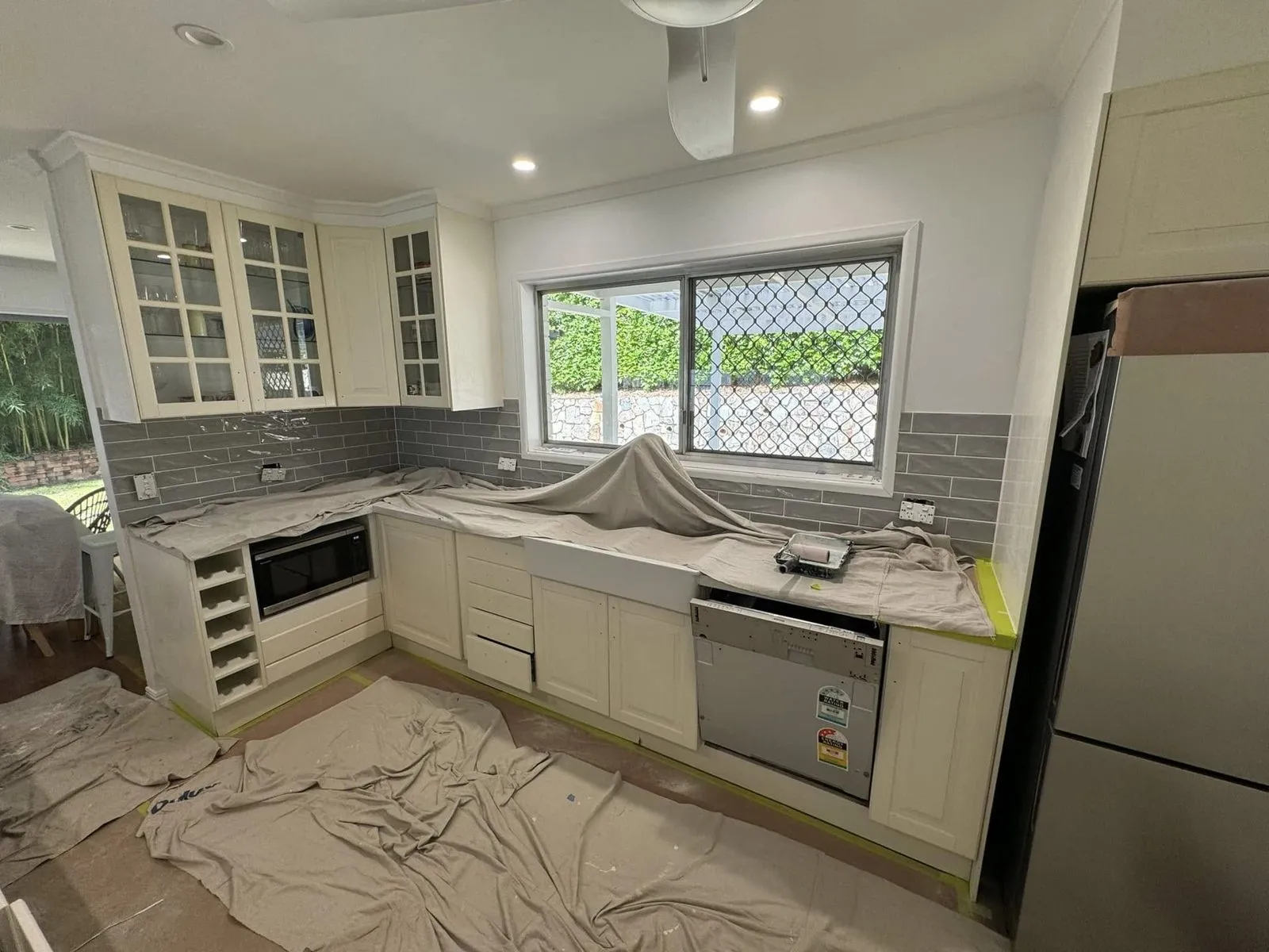 Before: Kitchen cabinets repainted white